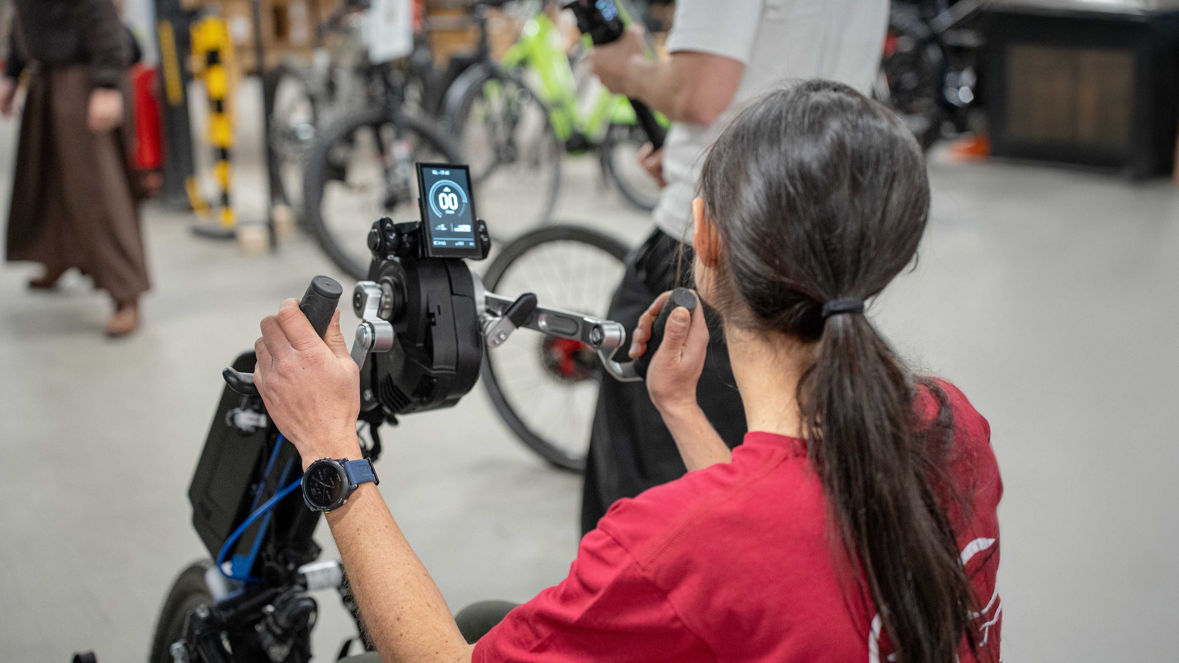 Une cycliste teste le cockpit PERS fixé au guidon, dans un atelier